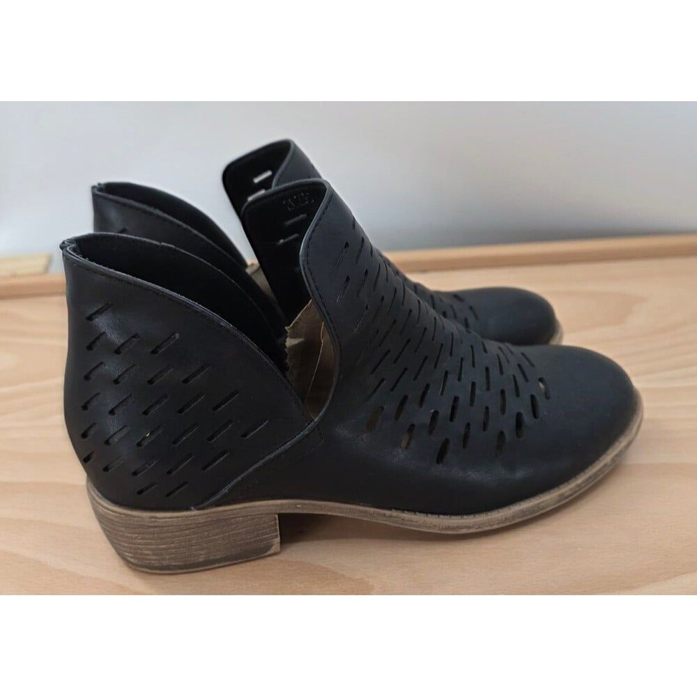 JG black ankle boots feature a perforated design and a low, stacked heel